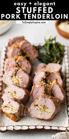 sliced pork on a platter with herbs