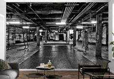 a black and white photo of an empty gym with equipment in the background wall mural