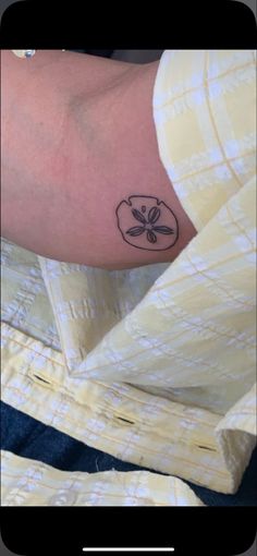 a person with a small tattoo on their arm