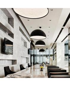 a long table with black chairs in a room