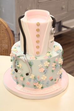 a cake decorated with flowers and a doctor's stethoscope on top