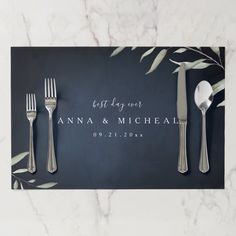 an elegant place setting with silverware and greenery on a marble tablecloth that reads, but they were annna & michael