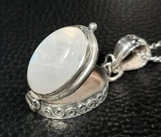 Moonstone locket pendant 925 Sterling silver Moonstone photo locket Moonstone gemstone  Keepsake 3-D box Photo locket Personalized jewelry Gemstone locket Charm box pendant June birthstone Rainbow moonstone Movable lid Secret compartment box pendant Moonstone box amulet Healing crystal Natural gemstones Anniversary gift Mother's gift Dimensions: Sterling silver chain length 50 cm  Pendant 3.5 x 1.6 cm Locket height 1.2 cm Moonstone 1.9 x 1.3 cm The inner depth is 0.3 cm, length and width 1.9 x 1 Sterling Silver Locket Necklace, Photo Locket Necklace, Locket Charms, Photo Locket, June Birthstone, June Birth Stone, Necklace Sterling Silver, Locket Necklace, Rainbow Moonstone