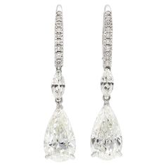 Finely crafted in 18k white gold with two GIA certified Pear Shaped diamonds. One weights 3.00 carats, H color, SI2 clarity GIA#2225366408 The other also weighs 3.00 carats, I color, SI1 clarity GIA#6224366414 The earrings feature Marquise and Round Brilliant cut diamonds weighing approximately a total of 0.80 carats. Diamond Dangle Earrings, Pear Shaped Diamond, Round Brilliant Cut Diamond, Brilliant Cut Diamond, Pear Shaped, Round Brilliant, Beautiful Earrings, Jewelry Stores, Antique Jewelry