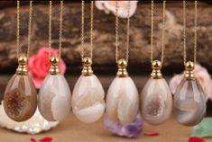 These perfume bottle necklaces measure about 1-1.5" tall and are edged in gold plating. A unique gift for yourself or others, these perfume bottles appear to be a trendy agate pendant with the added value of holding your favorite perfume! These agate perfume bottles are polished with rough geode accents displayed.Each piece is similar, though no item at Crystal Joys is exactly the same as every item uses a unique stone that is non-fabricated. Every item at Crystal Joys is a true "one of a kind". Gold Agate Crystal Necklace For Gifts, Agate Amulet Crystal Necklace With Gemstone, Agate Pendant Crystal Necklace For Gift, Gold Agate Crystal Necklace With Round Pendant, Gold Agate Round Pendant Crystal Necklace, Adjustable Agate Crystal Pendant Necklace, Hand-strung Agate Crystal Necklace As Gift, Bohemian Agate Crystal Necklace Hand-strung, Coin Earrings