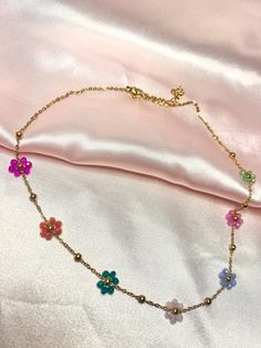 This beautiful gold choker necklace has colorful beaded flowers on it! Perfect detail to any outfit!  Sizing: Length is about 15-17 inches Material: stainless steel Gold Chain Choker, Fuzzy Socks, Gold Choker Necklace, Gold Choker, Chain Choker Necklace, Chain Choker, Stainless Steel Chain, Beaded Flowers, Pressed Flowers