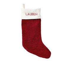 a red christmas stocking with the name lauren on it and a white tag that says,