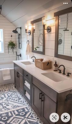 a bathroom with two sinks, mirrors and a bathtub in the middle of it