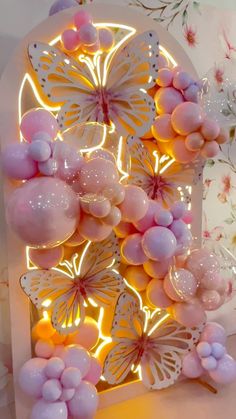 a decorative display with balloons and butterflies on it