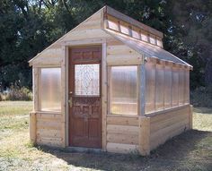 a small wooden building with a glass door