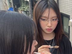 two girls are looking at something in the mirror