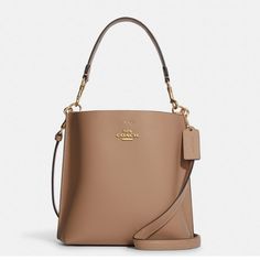 Double Face Leather Center Zip Compartment Snap Closure Detachable Handle With 6 3/4" Drop Detachable Strap With 22" Drop For Shoulder Or Crossbody Wear 8" (L) X 8 1/2" (H) X 4" (W) Style No. Ca177 Taupe Crossbody Bag For Formal Occasions, Coach Beige Bucket Bag, Classic Beige Bucket Bag For Evening, Coach Beige Bucket Bag With Removable Pouch, Beige Bucket Bag For Evening, Beige Evening Bucket Bag, Coach Beige Bucket Shoulder Bag, Coach Beige Bucket Bag For Shopping, Elegant Neutral Bag With Removable Pouch