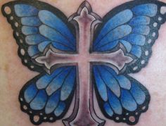 a blue butterfly with a cross tattoo on it's back shoulder and chest area