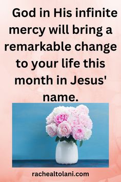 a white vase filled with pink flowers on top of a blue table next to a quote that reads, god in his infinite mercy will bring a remarkable change to your life