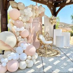 an outdoor area decorated with balloons and chairs