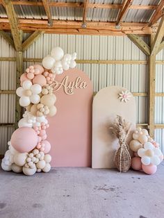 balloons and flowers are arranged on the floor in front of a sign that says, alya