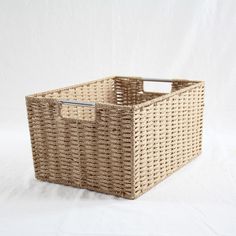 a wicker basket with metal handles on a white background and the words home stories written below it