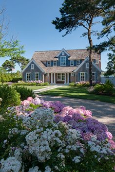 a house with flowers in the front yard