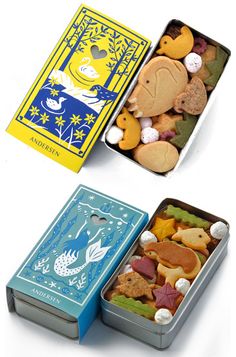 two tins filled with different types of cookies in each one's own box