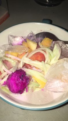 a white plate topped with lots of veggies and ice cream on top of a table