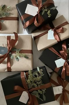 several wrapped presents with ribbons and tags on them