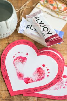 valentine's day crafts for kids with handprinted footprints and candy bar wrappers