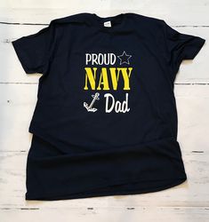 Proud Navy Family shirt. We love our original design! Thank you for your families service! You add the proud Navy family names - Mom, Sister, Brother, Wife, Husband, Lil Brother, Uncle, Aunt, Nana, Girlfriend, Grandma, best friend, Aunt and so many more. These are yellow and white ink design (not vinyl). If you want all white, please just let us know. These are all Navy color shirts. **Baby items will have an adjusted logo design due to small, cuteness size of clothing :). **LADIES CUTS RUN SMAL Funny Custom Print T-shirt For Father's Day, Father's Day Blue T-shirt With Text Print, Father's Day Family Cotton T-shirt, Blue Family Graphic Print T-shirt, Pre-shrunk Crew Neck T-shirt For Family, Customizable Blue T-shirt For Family, Father's Day Family Matching Pre-shrunk T-shirt, Customizable Crew Neck T-shirt For Family, Father's Day Graphic Tee With Custom Print