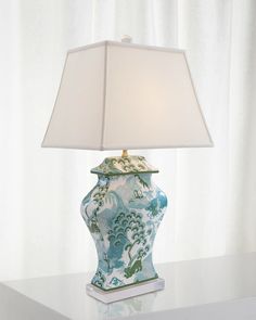 a blue and white lamp sitting on top of a table