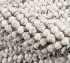 a close up view of a white and black rug