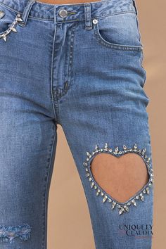 Indulge in effortless sophistication with the enchanting allure of our Dacia Embellished Heart Cut Out Denim Ankle Jeans. Crafted to captivate, these jeans redefine elegance with a touch of whimsy. Adorned with delicate rhinestone embellishments, the right pocket exudes a subtle yet radiant sparkle, while the heart-shaped cutout on the left leg steals the spotlight, meticulously adorned with glistening rhinestones that shimmer with every movement. The artful combination of distressed accents and Diy Lace Jeans, Bedazzled Jeans, Scarf Coverup, Button Heart, Cut Out Jeans, Rebecca Black, Rhinestone Jeans, Heart Cut Out, Kids Scarf