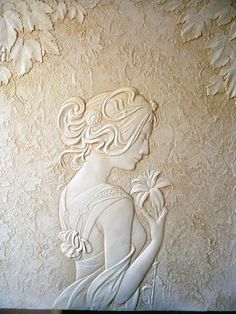 a woman with flowers in her hair is depicted on the wall