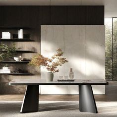 a modern dining table in the middle of a room with bookshelves and shelves