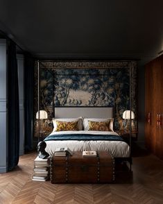 a bedroom with a canopy bed, wooden floors and blue wallpaper on the walls