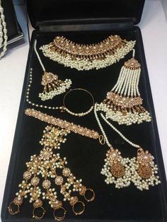 an assortment of jewelry is displayed on a table