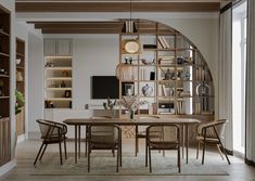 a dining room table and chairs in front of a bookshelf