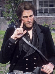 a man dressed in black pointing at something