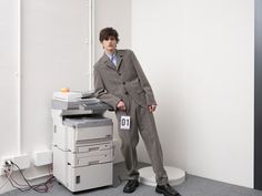 a man standing in front of a printer