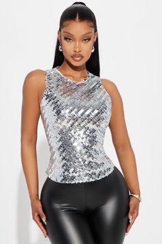 Available In Silver. Sequin Top Sleeveless Crew Neck Open Back Tie Back Fully Lined Non Stretch Shell/Lining: 100% Polyester Contrast: 96% Polyester 4% Spandex Imported | Stand Out Sequin Top in Silver size XS by Fashion Nova Sleeveless Top Outfit, Silver Sequin Top, Silver Shirt, Silver Fits, Rhinestone Top, Woman Standing, Women Shirts Blouse, Silver Sequin, Sequin Top