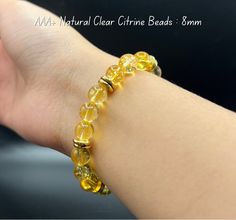 "---------------------------------------  Natural Clear Citrine : 8mm --------------------------------------- Citrine Bracelet: Feng Shui and Spiritual Benefits 1. Citrine Gemstone - Royal Jade: Color Properties: Citrine is a variety of quartz ranging from pale to deep yellow, symbolizing positive energy and warmth. 2. Feng Shui Benefits: Attracts Opportunities and Prosperity: Citrine is believed to have the ability to attract business opportunities and wealth, serving as a symbol of prosperity. Stress Reduction and Energy Boost: It is known as a \"happy stone,\" helping to reduce stress, anxiety, and enhance positive energy. Supports Decision-Making: Citrine is thought to enhance creativity and positive thinking, providing support in the decision-making process. 3. Spiritual and Mental As Yellow Citrine Crystal Bracelet Gift, Citrine Crystal Bracelet Gift, Color Properties, Earth Elemental, Happy Stone, Jade Color, Deep Yellow, Citrine Bracelet, Bracelet Metal