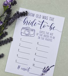 a purple flower next to a white paper with the words how old was the bride - to - be written on it