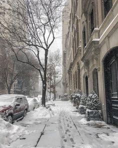 a snowy street with cars parked on it