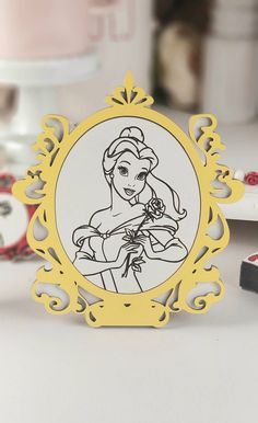 an image of a princess in a frame on a table with other items around it