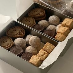 two boxes filled with different types of cookies