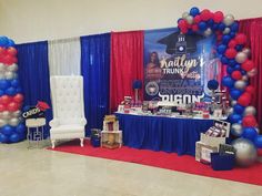 an event with balloons and decorations on the floor, including a table set up for a graduation party