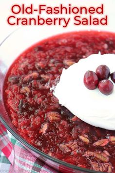 an old fashioned cranberry salad in a glass bowl with whipped cream on top