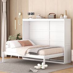 a white bed sitting on top of a wooden floor