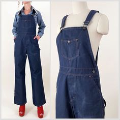 70s indigo dark wash wide leg bib overalls. Stiff denim fabric, may be a blend, with orange contrast stitching, embossed buttons and carpenter pockets. Seem almost unworn except for a fade on the leg - please see photos. In overall great vintage condition.   All measurements are taken with the garment laying flat and doubled for the bust, waist, and hips.  Waist: 32" Hips: 40" Rise to Waist: 12.5" (taken at top of waistband) Rise to Shoulder: 31" at longest strap length / 28" at shortest strap length Upper Thigh: 12.5"across Inseam: 29.5" Length (shoulder to hem): 59" at longest strap length / 56" at shortest strap length Label: Missing Size on Tag: N/A Approx. Fit: 29-31 waist depending on desired fit  Some garments have been adjusted in photos to fit the form. Please reference measuremen Denim Bib Front Jeans For Workwear, Medium Wash Bib Front Jeans For Work, Dark Wash Denim Bib Front Jumpsuit For Work, Dark Wash Denim Jumpsuit For Workwear With Bib Front, Dark Wash Denim Jumpsuit For Work, Dark Wash Utility Denim Jumpsuit With Bib Front, Utility Style Dark Wash Denim Jumpsuit With Bib Front, Dark Wash Wide Leg Overalls With Pockets, Wide Leg Dark Wash Overalls With Pockets