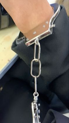 a person is holding onto a metal chain