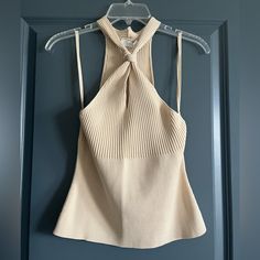 Tan/Cream Colored, Sleeveless Sweater Top. Keyhole Detail In Front. Chic Beige Sleeveless Halter Top, Beige Stretch Sleeveless Halter Top, Chic Beige Fitted Halter Top, Chic Fitted Beige Halter Top, Fitted Beige Chic Halter Top, Fitted Beige Sleeveless Top, Fitted Sleeveless Beige Top, Chic Beige Halter Neck Tank Top, Elegant Beige Tank Top For Day Out