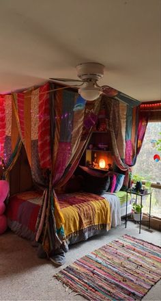 a bedroom with a canopy bed covered in colorful fabric